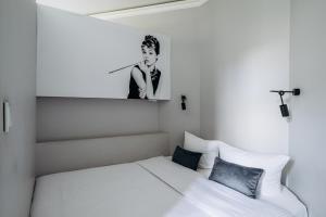 sypialnia z łóżkiem i zdjęciem mężczyzny w obiekcie Apartament Marylin w Krakowie