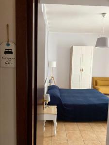 een slaapkamer met een blauw bed en een tafel bij Rifugio della Cascata in Collestatte