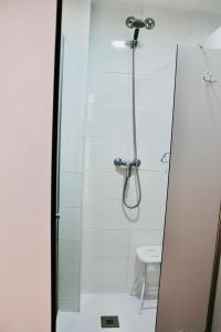 a bathroom with a shower and a sink at Albergue Puente para peregrinos in Puente la Reina
