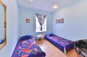 a bedroom with blue walls and a blue bed at Central Hostel in Riga