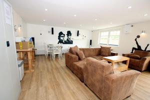 a living room with a couch and a table at Susanne-Fischer Weg 39, Haus Knurrhahn in Wyk auf Föhr