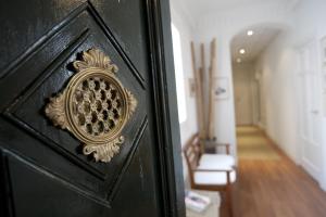 a black door with a gold design on it at Hostal Santa Isabel in Madrid