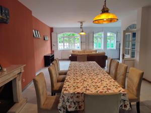 uma sala de jantar com uma mesa longa e cadeiras em Alameda House em Santa Marta de Ortigueira