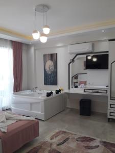 a bathroom with a tub and a large mirror at Villa Ayla in Fethiye