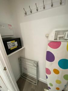 a laundry room with a drying rack and a refrigerator at Modern 2 bedroom apartment, with car parking. in Oldland Common +9 photos