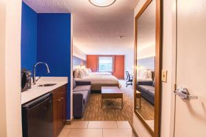 a hotel room with a bed and a bathroom at Holiday Inn Express & Suites - Lincoln East - White Mountains, an IHG Hotel in Lincoln