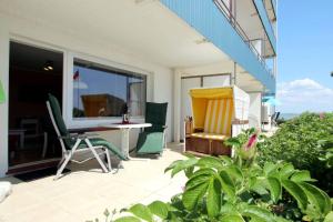a patio with a table and chairs on a balcony at Koenigstr_5_ Whg_ 7_ Atlantischer in Wyk auf Föhr