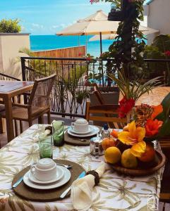 a table with plates of food on it with a view of the ocean at Beach Eco Stays Hotel Boutique Lagoinha in Paraipaba