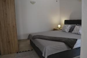 a bedroom with a bed and a wooden door at Cherry in Korčula