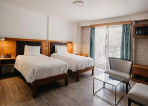 Postel nebo postele na pokoji v ubytování La Hostería Boutique Hotel