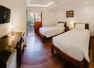 Postel nebo postele na pokoji v ubytování La Hostería Boutique Hotel