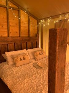 a bedroom with a bed with lights on it at Little North Field in Harrogate