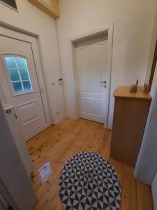an empty room with a door and a wooden floor at Dona 2 in Sarajevo