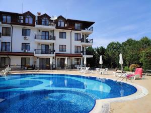 a large swimming pool in front of a building at Sirena condo 50 m from the central beach in Byala