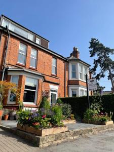 una casa de ladrillo con flores delante en The Hathaways, en Stratford-upon-Avon