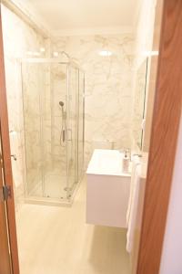 a bathroom with a shower and a sink at Casa Das Eiras in Macedo de Cavaleiros +20 photos