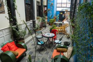 a patio with a table and chairs and a table at Villa Bonita Hostel in Riobamba