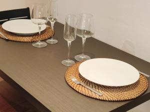 a table topped with white plates and wine glasses at BAKEA in Bermeo +6 photos