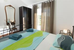 a bedroom with a bed with blue towels on it at Cipra Apartments in Okrug Donji +53 photos