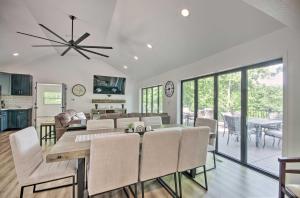 a dining room and living room with a table and chairs at Waterfront Gravois Mills Home Deck and Grill! in Gravois Mills