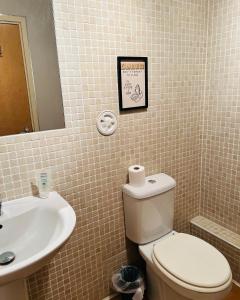 a bathroom with a toilet and a sink at MODERN 2bed 2bath Ground Floor Apartment in Edinburgh