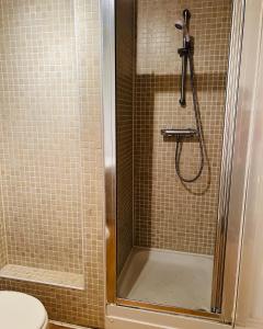 a shower in a bathroom with a toilet at MODERN 2bed 2bath Ground Floor Apartment in Edinburgh