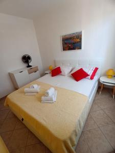 a bedroom with a large bed with towels on it at Apartments Dario in Pag
