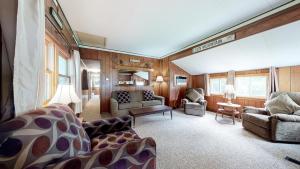 a living room with a couch and chairs in a train car at Riverbank's Pemi Cottage in Lincoln