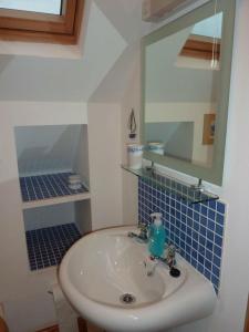 a bathroom with a sink and a mirror at Taigh Geal in Stornoway