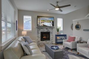 a living room with a couch and a fireplace at Sea Swept Mermaid Oyhut Bay Seaside Village in Ocean Shores