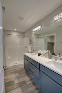 a bathroom with two sinks and a large mirror at Sea Swept Mermaid Oyhut Bay Seaside Village in Ocean Shores