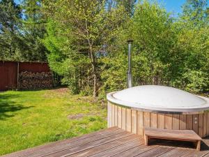 a jacuzzi tub sitting on a deck in a yard at 6 person holiday home in Hemmet in Hemmet