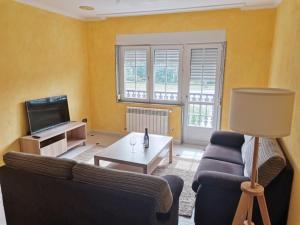 a living room with a couch and a table at Casa da Pioxa in Camariñas