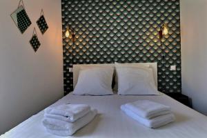 une chambre avec un lit avec des serviettes dessus dans l'établissement Appartement "PANNA" centre ville de VITRÉ, à Vitré