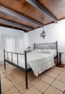 a bedroom with a black bed in a room at Nostalgia Suites in Faliraki