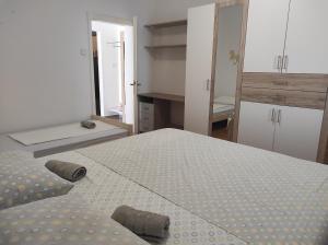 a small bedroom with a bed and a mirror at Apartmani Marija in Sveta Nedelja
