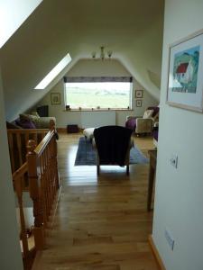a room with a staircase and a living room at Taigh Geal in Stornoway