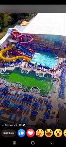 a view of a water park with a pool at Pensiunea Adeluta in Călimăneşti
