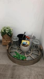 a wooden tray with bowls and utensils on a table at Apartmani Statik SD in Smederevo