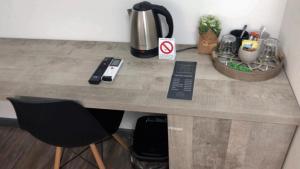 a counter with two chairs and a coffee maker on it at Apartmani Statik SD in Smederevo