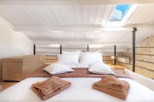 a bedroom with a large bed in a attic at Art Loft Venetian Well in Corfu Town