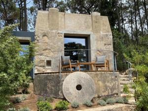 a stone house with two chairs and a table at Quinta Vale da Roca in Sintra
