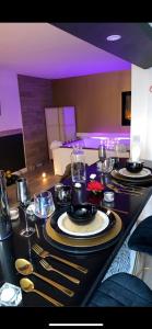una mesa con platos y cubiertos. en Cocooning Bed&Spa en Toulouse