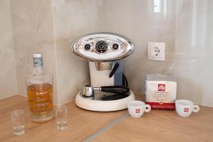 a coffee maker sitting on a table with two cups at Dream House Ioannina in Ioannina