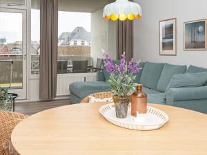 a living room with a table and a blue couch at 4 person holiday home in Fan in Fanø