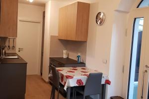 a small kitchen with a table with a table cloth at Appartamento Carta da Zucchero in Riva del Garda