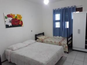 a bedroom with two beds and a window at chácara ouro verde in Beberibe +20 photos