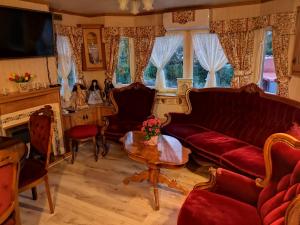 a living room filled with furniture and a red couch at Agroturystyka u Kozdryka in Leśna