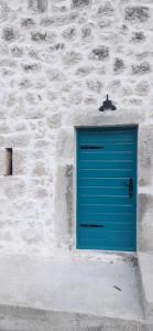 a blue garage door on a stone wall at Old Lato's House in Danilovgrad