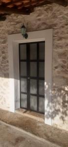 a door in a stone building with a lamp above it at Old Lato's House in Danilovgrad